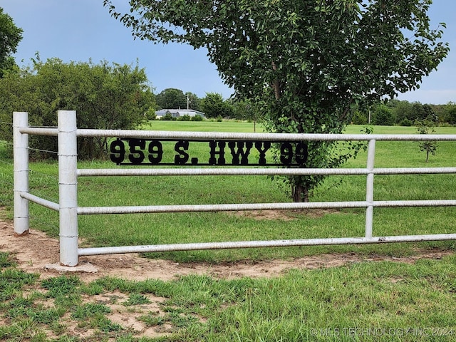 view of gate with a rural view