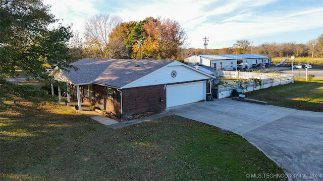 view of front of house featuring a garage and a front lawn