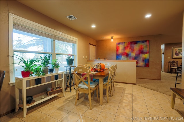 dining space featuring light tile patterned flooring