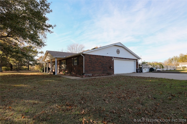 view of front of property with a garage and a front lawn