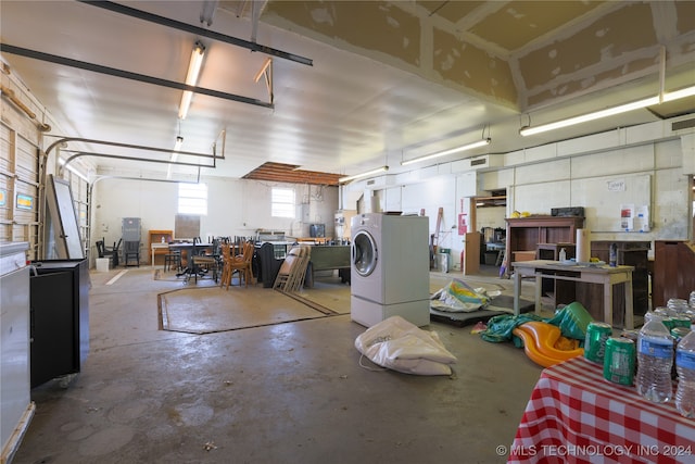 garage with a workshop area and washer / dryer