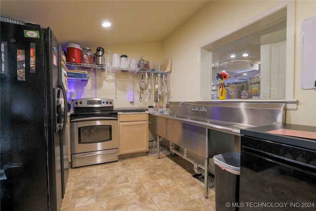 kitchen with light brown cabinets, black fridge, and stainless steel electric stove