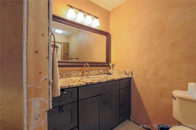 bathroom with tile patterned floors, vanity, and toilet