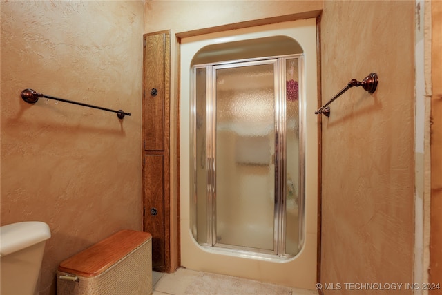 bathroom with a shower with shower door