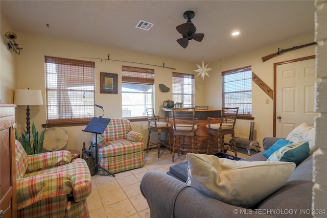 tiled living room with ceiling fan