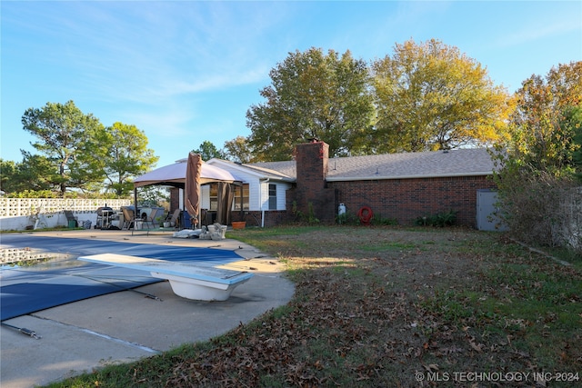 rear view of property with a gazebo and a patio area