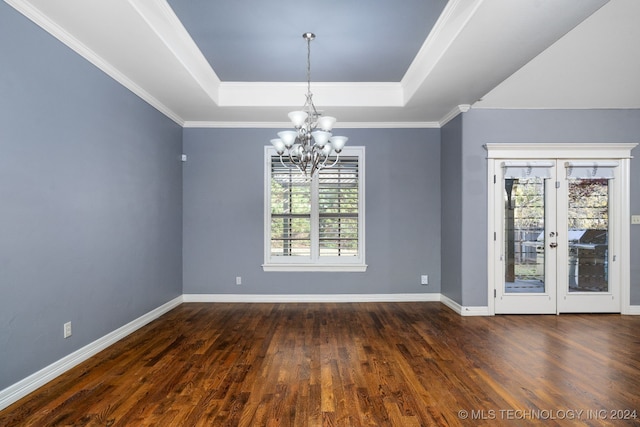 unfurnished room with a chandelier, ornamental molding, a wealth of natural light, and dark wood-type flooring