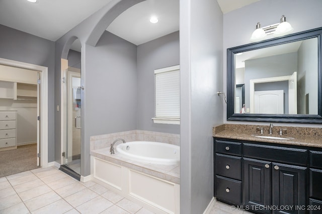 bathroom with tile patterned floors, vanity, and independent shower and bath