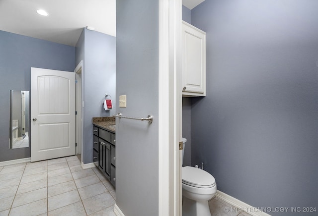 bathroom with tile patterned floors, vanity, and toilet