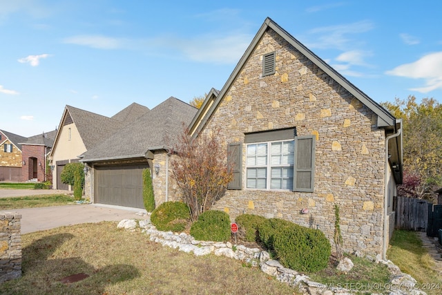 view of front property with a garage and a front lawn