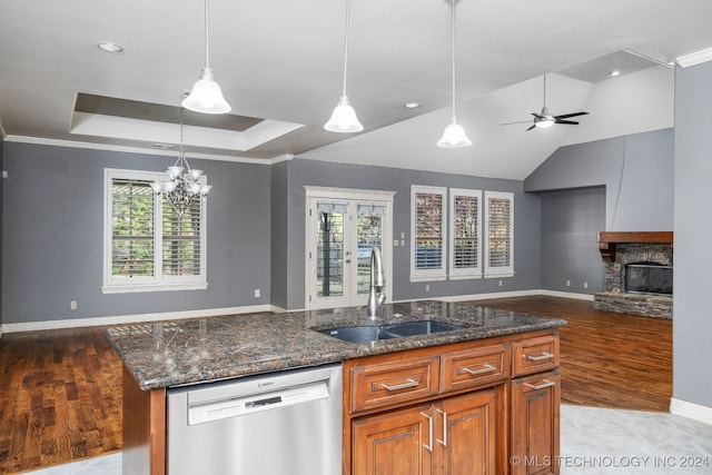 kitchen with dishwasher, light hardwood / wood-style floors, dark stone countertops, and sink