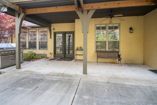 view of patio featuring ceiling fan, area for grilling, and french doors