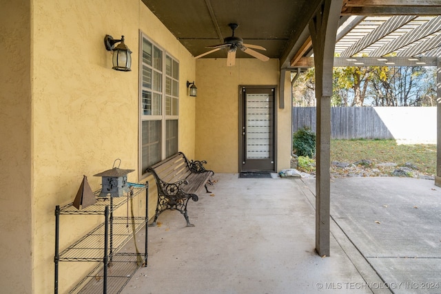 view of patio featuring ceiling fan and a pergola