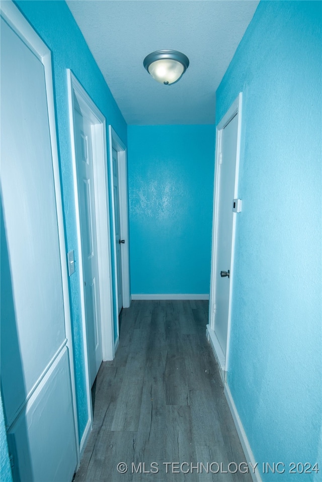 corridor featuring dark wood-type flooring