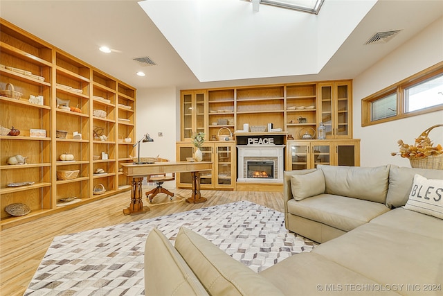 interior space featuring wood-type flooring and a skylight