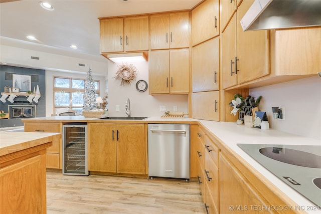 kitchen with exhaust hood, sink, stainless steel dishwasher, light hardwood / wood-style floors, and beverage cooler