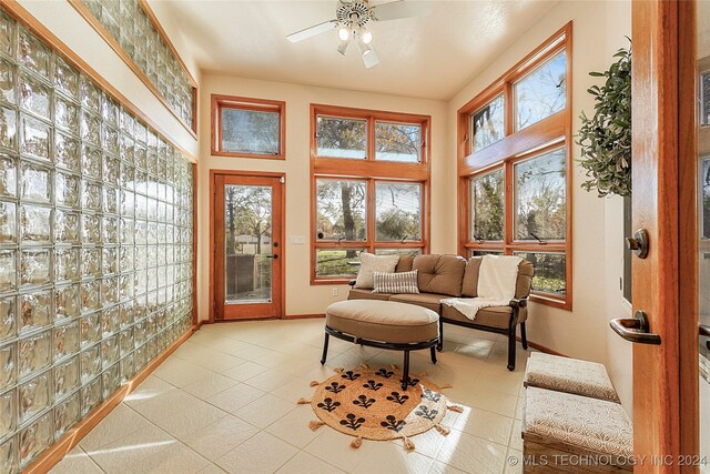 sunroom with a wealth of natural light and ceiling fan