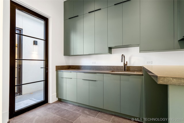 kitchen featuring sink and green cabinetry