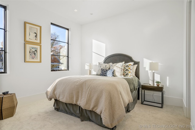 bedroom featuring light colored carpet