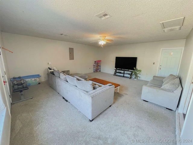 living room featuring a textured ceiling, light colored carpet, ceiling fan, and electric panel