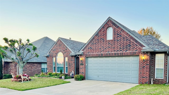 view of front facade with a lawn and a garage