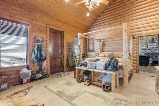 bedroom with wooden ceiling, high vaulted ceiling, and log walls