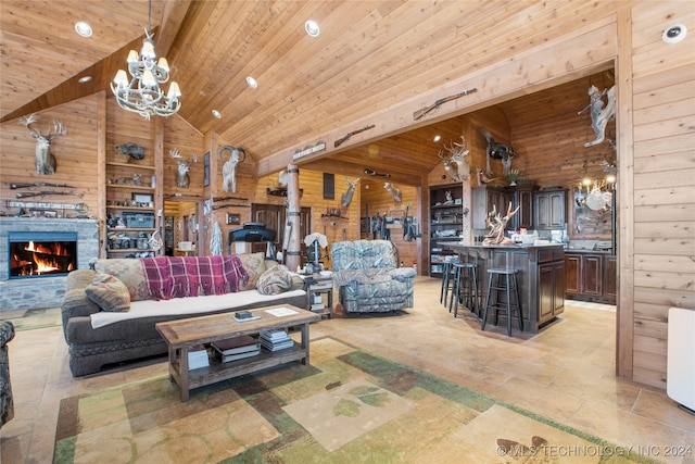 living room featuring wood walls, a fireplace, high vaulted ceiling, and wooden ceiling