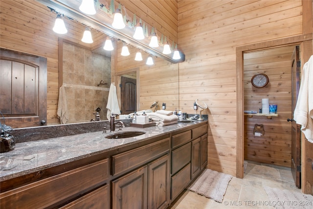 bathroom featuring wood walls and vanity