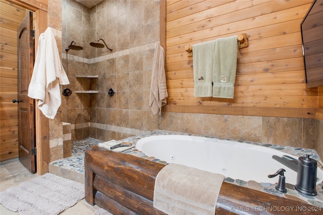 bathroom with separate shower and tub and wood walls