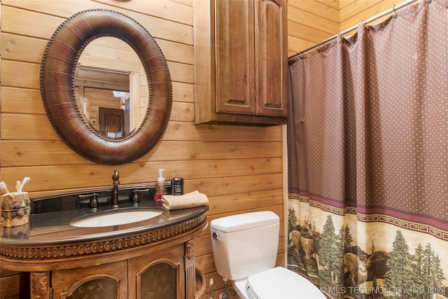 bathroom featuring vanity, toilet, walk in shower, and wooden walls