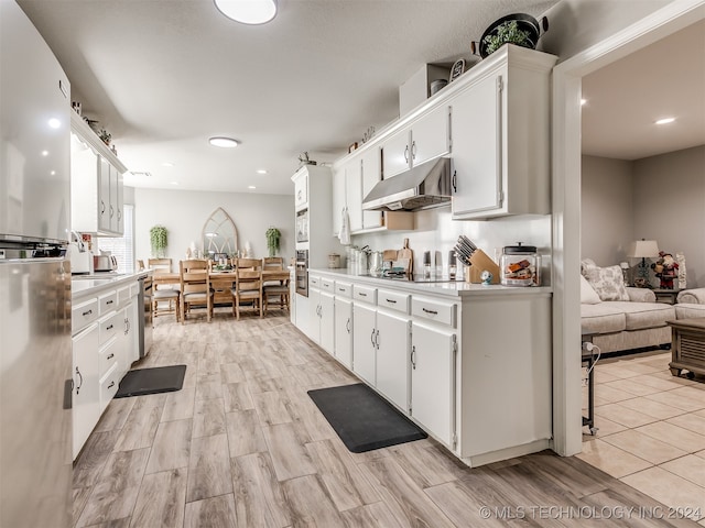 kitchen featuring white cabinets, stainless steel appliances, and light wood-type flooring