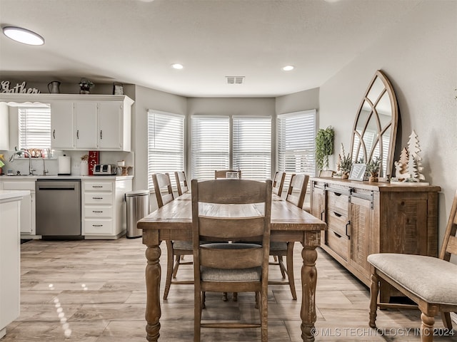 dining room featuring plenty of natural light and light wood-type flooring