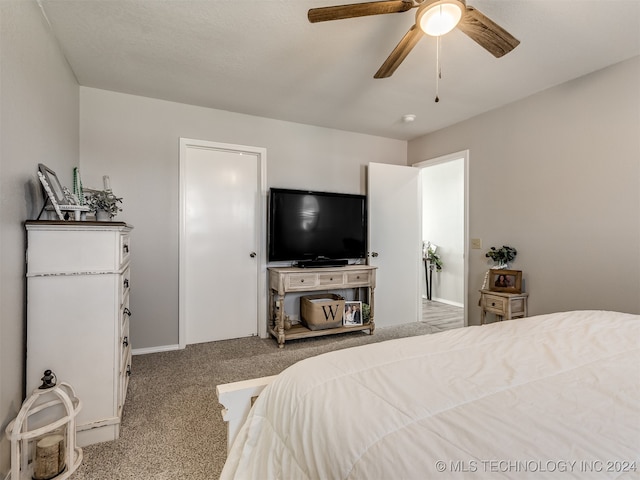 bedroom with ceiling fan and light carpet