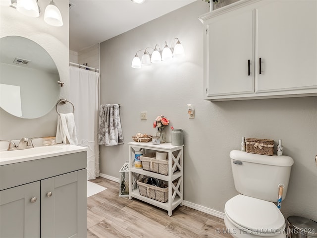 bathroom featuring vanity, toilet, and wood-type flooring