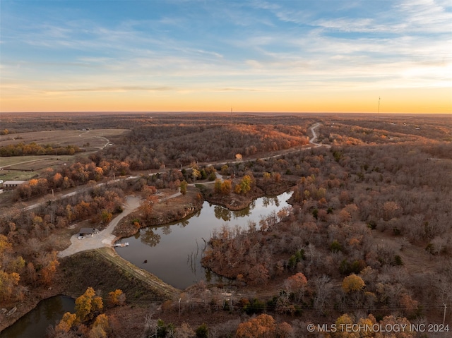 aerial view at dusk with a water view