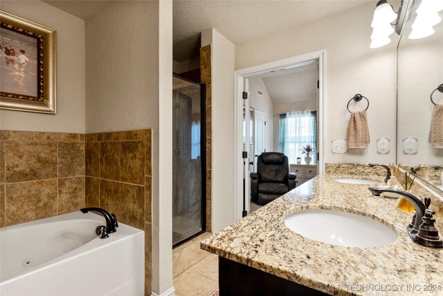 bathroom featuring plus walk in shower, vanity, and tile patterned floors