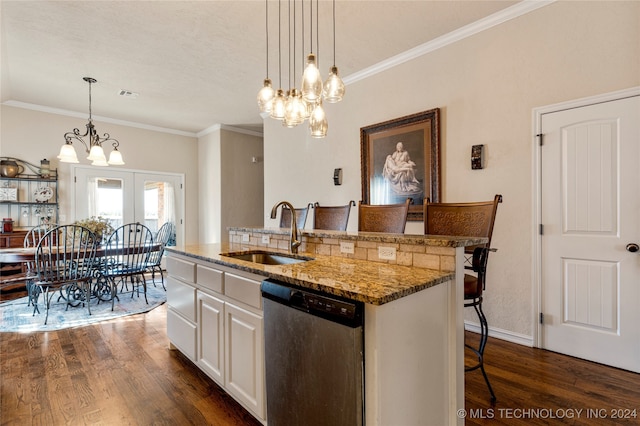 kitchen with a kitchen bar, stainless steel dishwasher, a kitchen island with sink, sink, and a chandelier