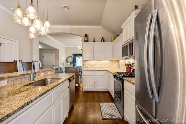 kitchen with hanging light fixtures, white cabinetry, sink, and stainless steel appliances