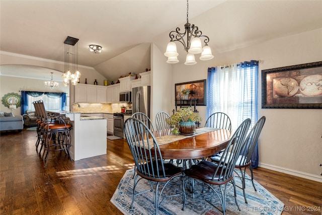 dining space with dark hardwood / wood-style flooring, an inviting chandelier, vaulted ceiling, and sink