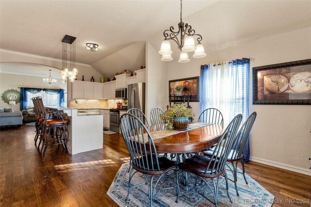 dining space with a chandelier, lofted ceiling, dark wood-type flooring, and baseboards