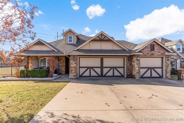 view of front of home with a garage and a front lawn