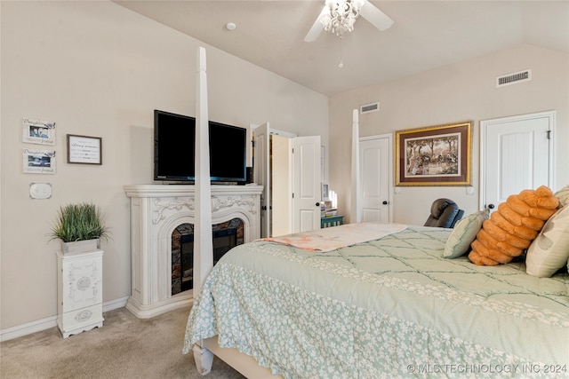 carpeted bedroom with ceiling fan and lofted ceiling