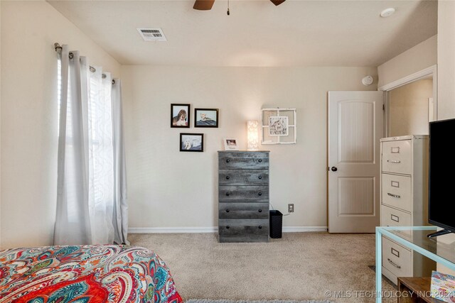 carpeted bedroom featuring baseboards, visible vents, and ceiling fan