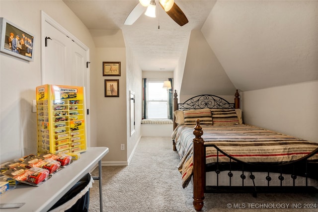 carpeted bedroom featuring a textured ceiling, ceiling fan, and lofted ceiling