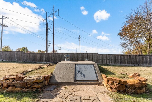 entry to storm shelter featuring a fenced backyard