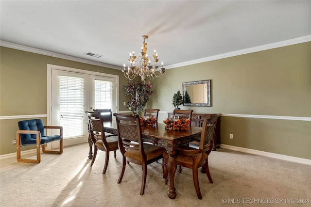 dining space featuring light carpet, a chandelier, and ornamental molding