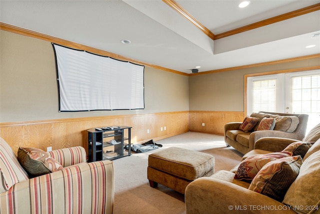 living room with wooden walls, light colored carpet, and ornamental molding