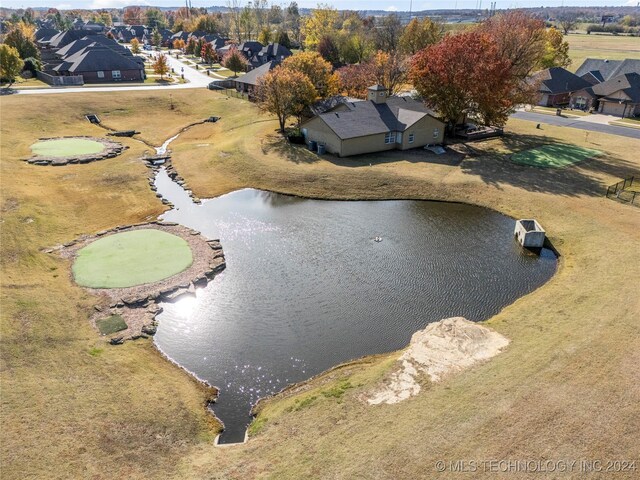 birds eye view of property featuring a water view and a residential view