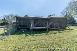 back of house with a lawn and a wooden deck