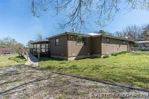 view of side of property with a yard